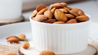 A white ceramic bowl of almond nuts