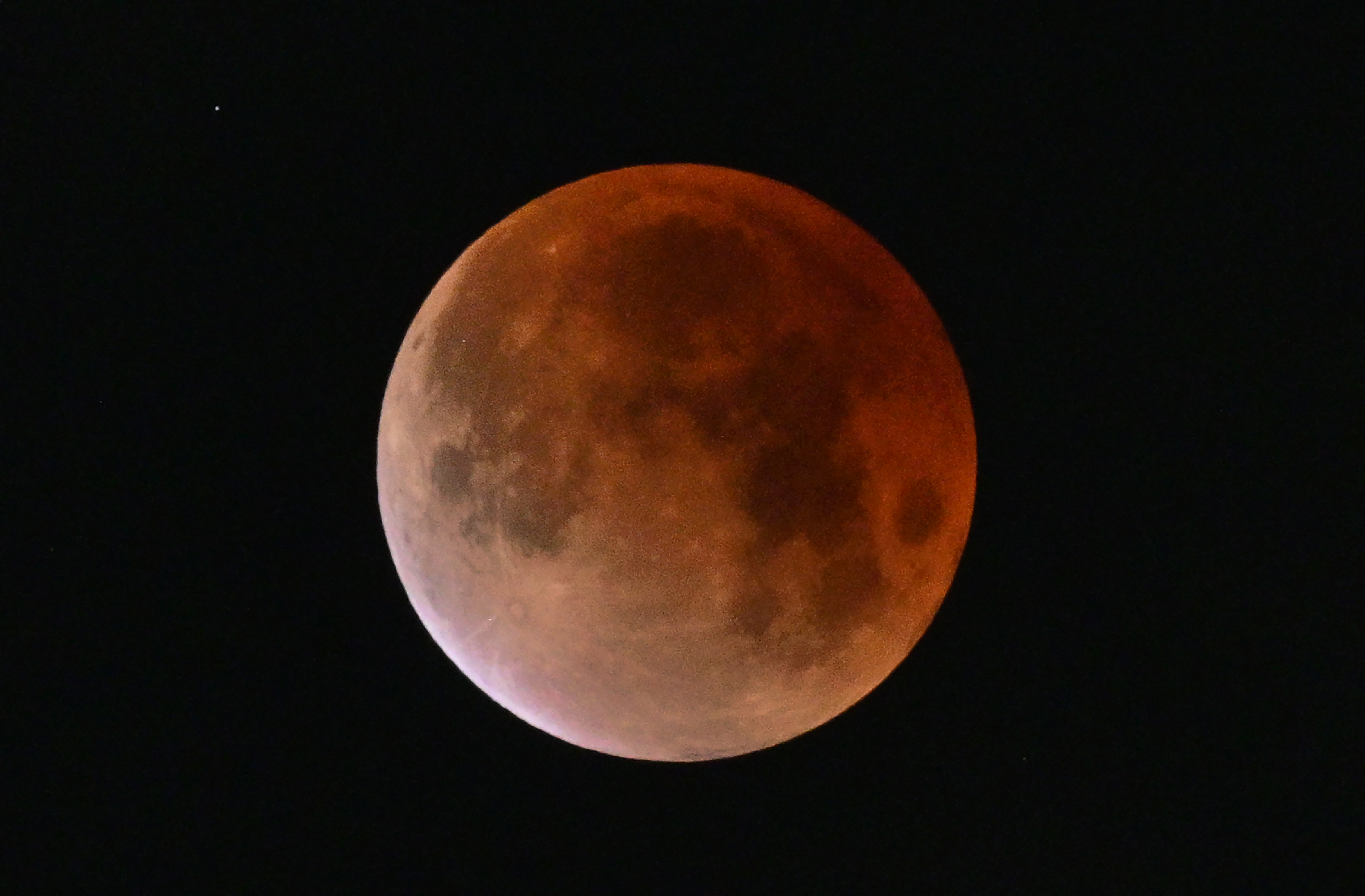 Photographer Frederic J. Brown captured the blood moon in partial shadow toward the tail end of the eclipse, which lasted roughly an hour