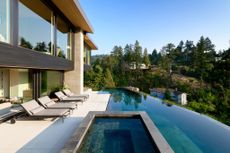 Maple Place house's exterior paved cascade of terraces with a long lap pool in the middle