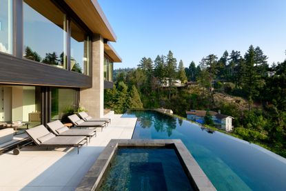 Maple Place house's exterior paved cascade of terraces with a long lap pool in the middle