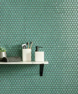 Green bathroom tiles with bathroom shelf