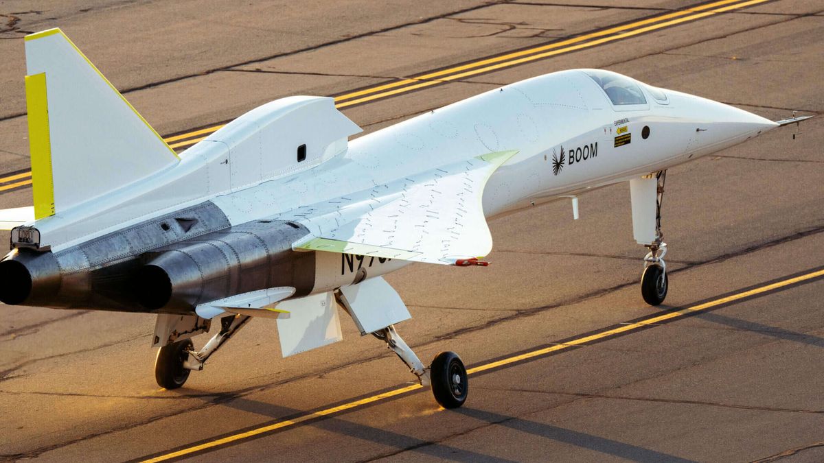 closeup photo of a needle-nosed white and silver plane on a runway