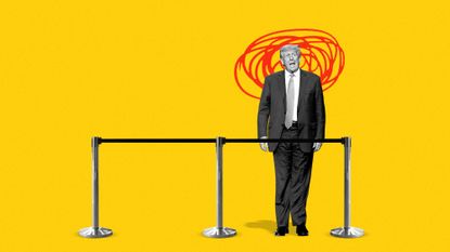 Donald Trump standing behind a ribbon barrier