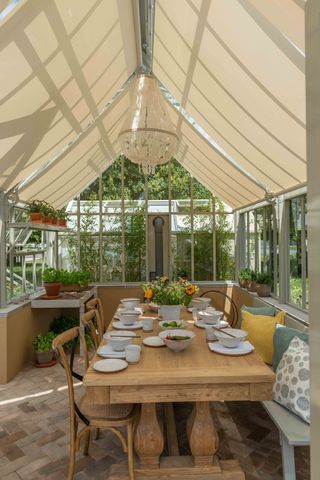 Greenhouse used for outdoor dining by Hartley Botanic