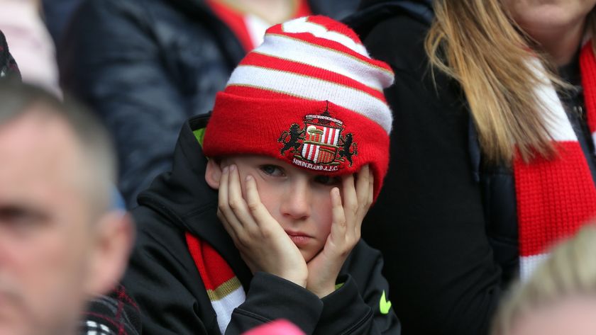 SUNDERLAND, ENGLAND - MAY 13: A young Sunderland fan holds his head in disappointment during the Premier League match between Sunderland and Swansea City at the Stadium of Light on May 13, 2017 in Sunderland, England. (Photo by Athena Pictures/Getty Images)