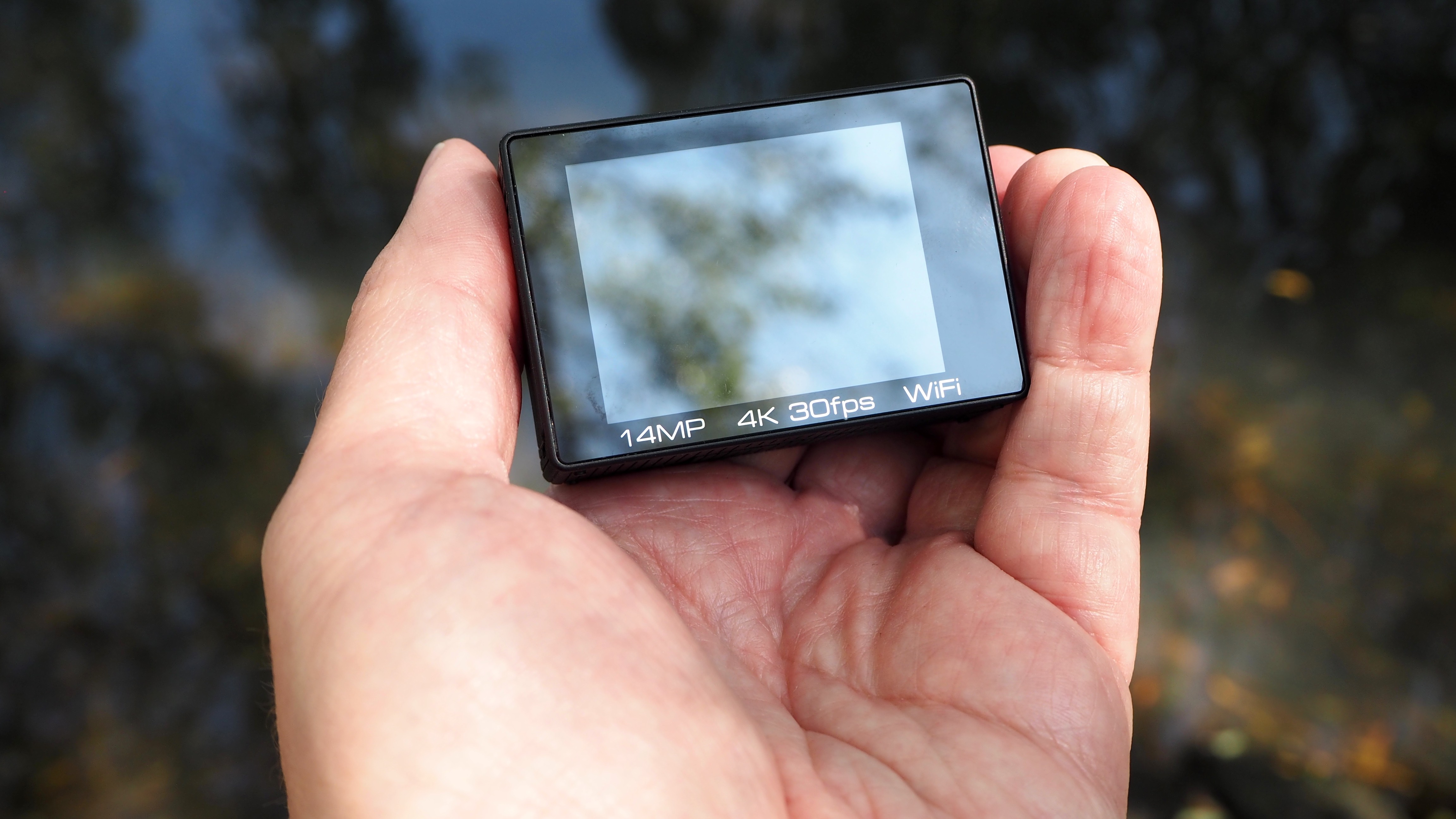 SeaLife ReefMaster RM-4K rear screen held in a hand outside