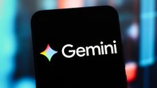 Google Gemini logo and branding pictured on a smartphone, with bar graph visuals blurred in background.
