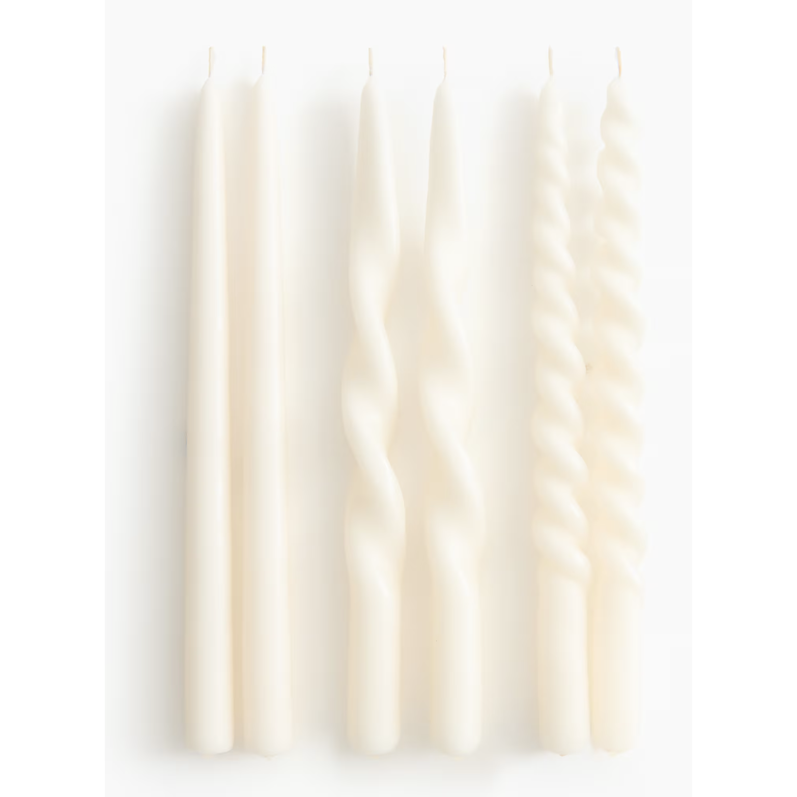 white taper candles with twists in them