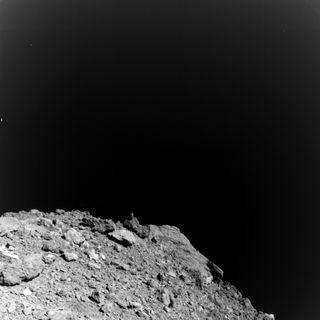 The first image captured by the MASCOT rover during its descent to Ryugu's surface.