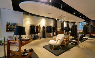 The design collection laid out in different sections of the stores shop floor featuring white walls, black and white ceiling design and beige flooring
