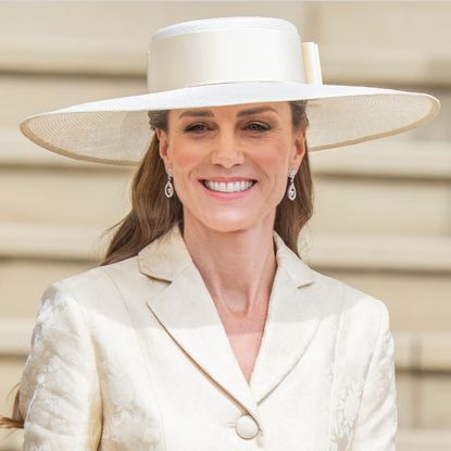 Princess Kate wearing a butter yellow coat and hat
