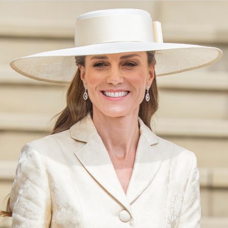 Princess Kate wearing a butter yellow coat and hat