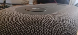 A grey Microsoft Audio Dock sitting on a wooden desk