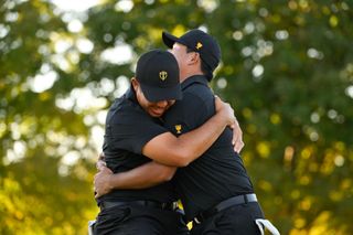 Byeong Hun An and Si Woo Kim celebrate defeating Scottie Scheffler and Russell Henley