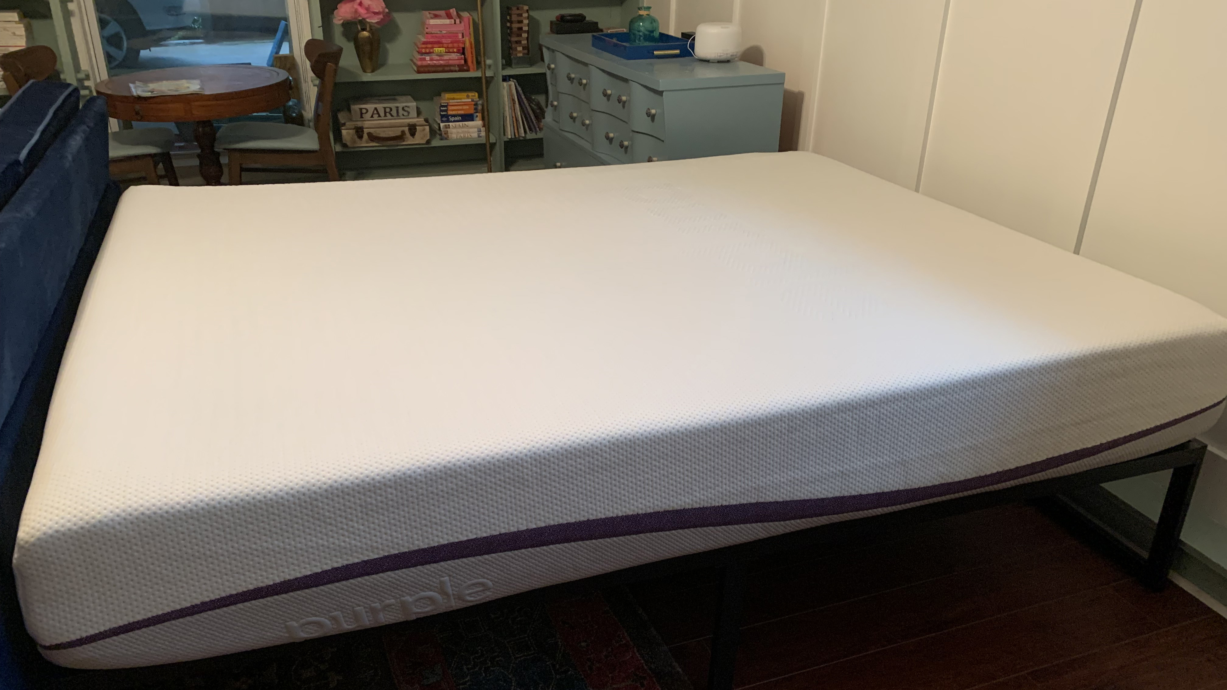 Image shows the Purple Plus mattress placed on a black metal bed frame, ready for review testing