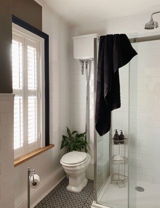 bathroom with white walls towel western commode