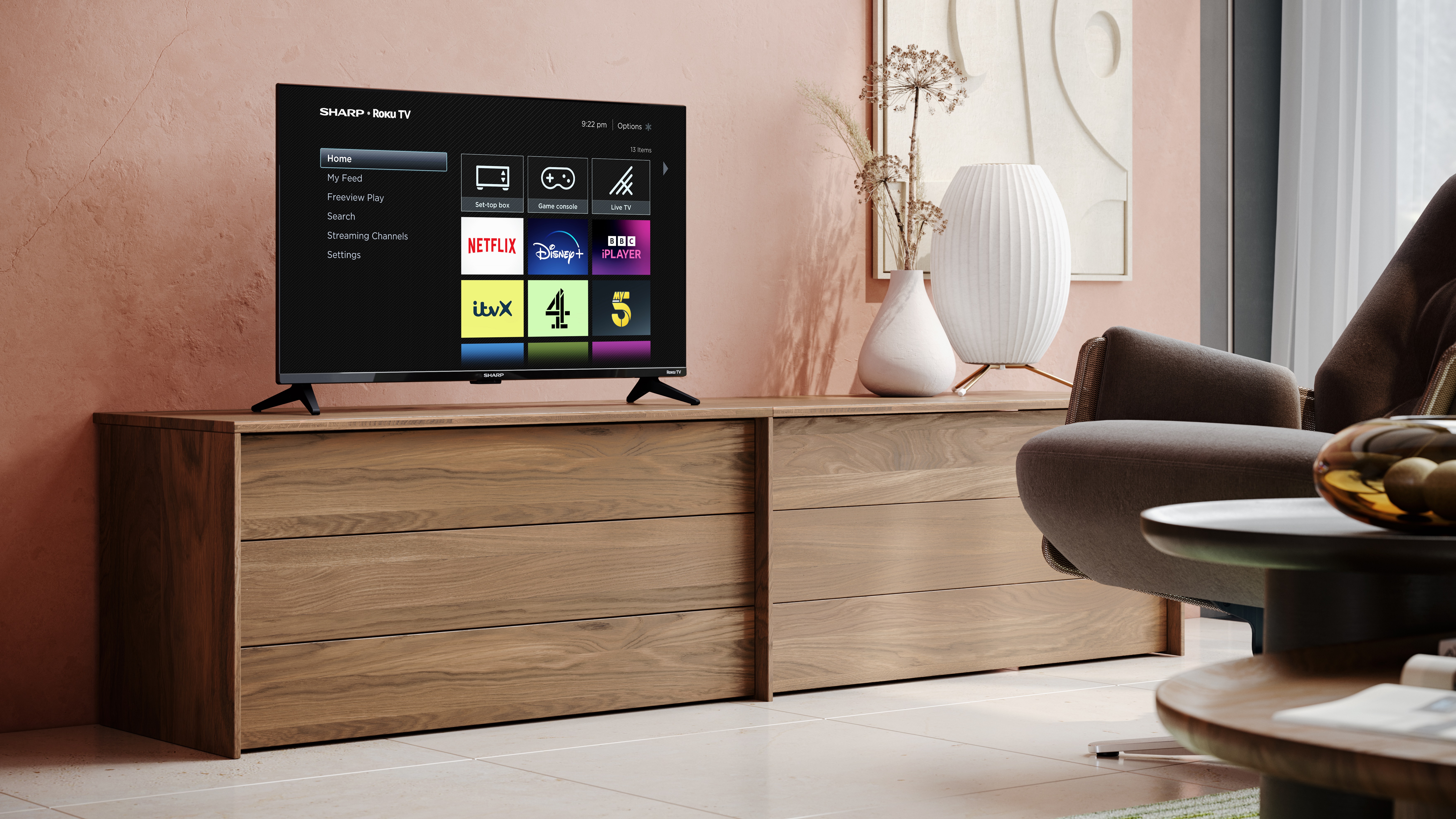 A Roku smart TV on a media unit showing the Roku home page