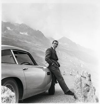 James Bond (Sean Connery) and his iconic Aston Martin DB5 which first appeared on screen in Goldfinger.