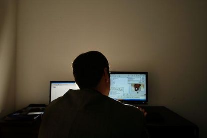 A man on a computer.