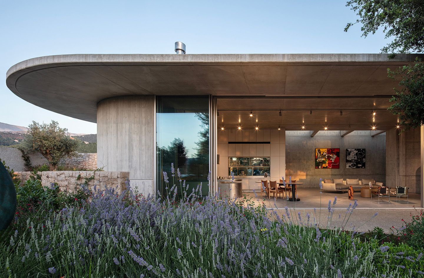 Concrete, curved house with open side