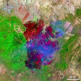 This Landsat 5 satellite image of the Wallow North Fire in east central Arizona was taken on June 15, 2011 at 19:54:23 Zulu (3:54 p.m. EDT). This false-colored image uses a 7, 4, 2 band combination and shows the burn scar in red the fire ongoing in really bright red, vegetation is green, smoke is blue and bare ground is tan.