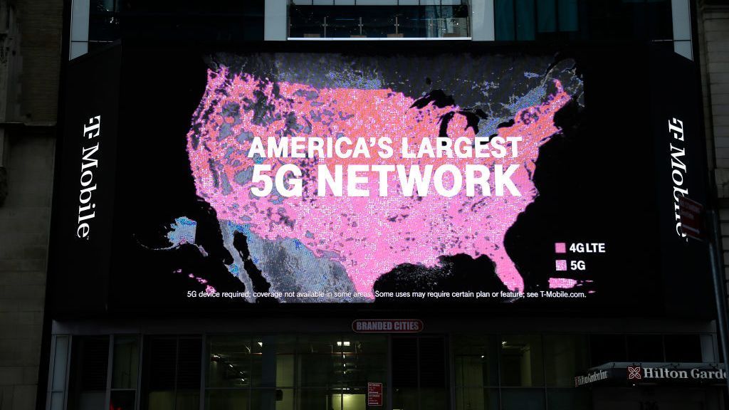 A T-Mobile advert above a doorway showing a map of the US with the words &amp;#039;America&amp;#039;s largest 5G network&amp;#039; displayed