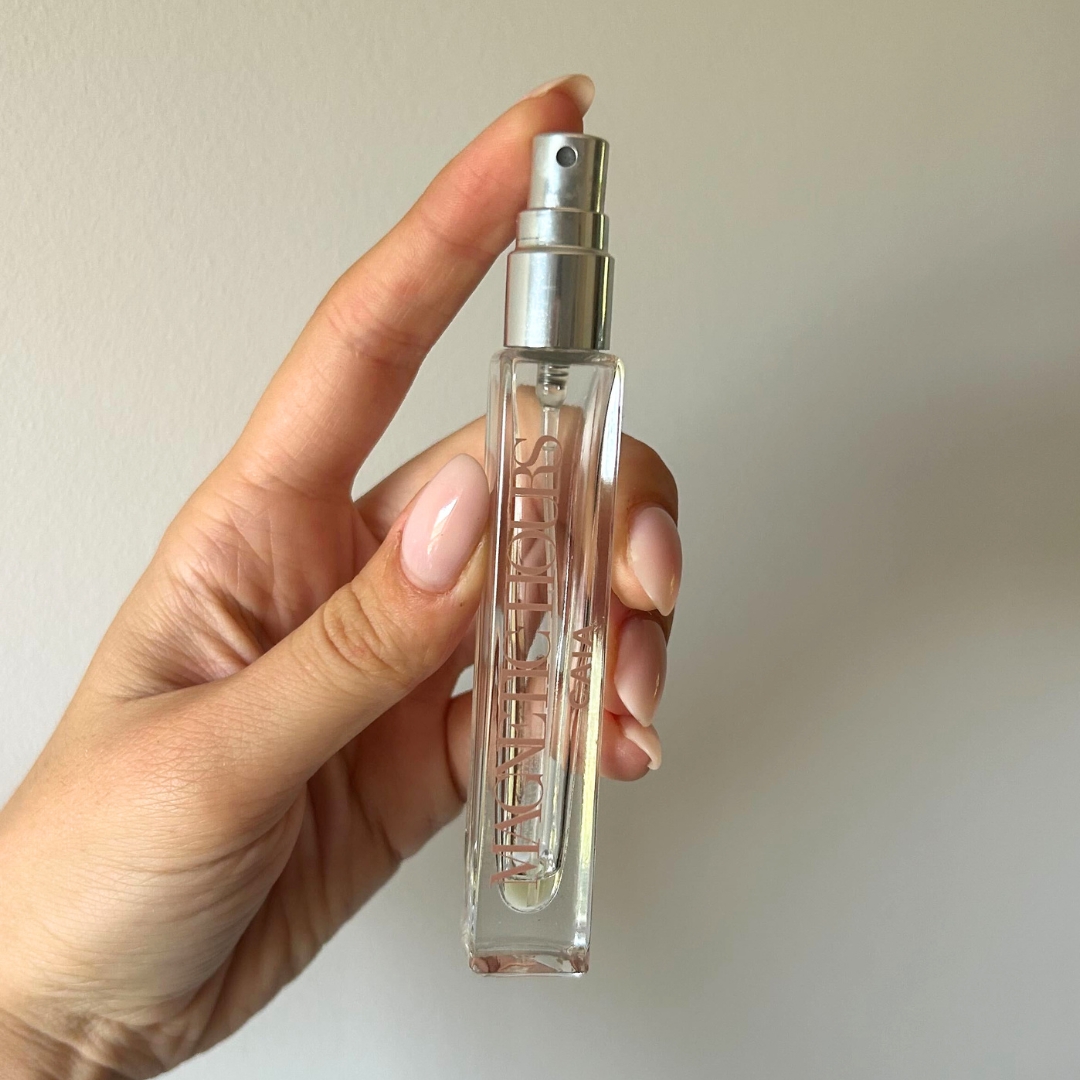 Hand holding empty bottle of CAIA Cosmetics Magnetic Hours 10ml