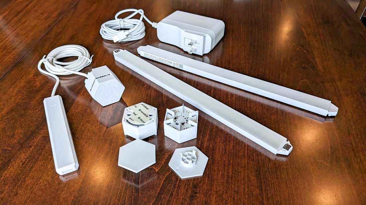 Nanoleaf Lines mounting connectors, line lights, charging adapter, and controller.