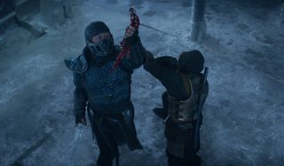 Mortal Kombat Sub Zero prepares to stab Scorpion with the blood blade