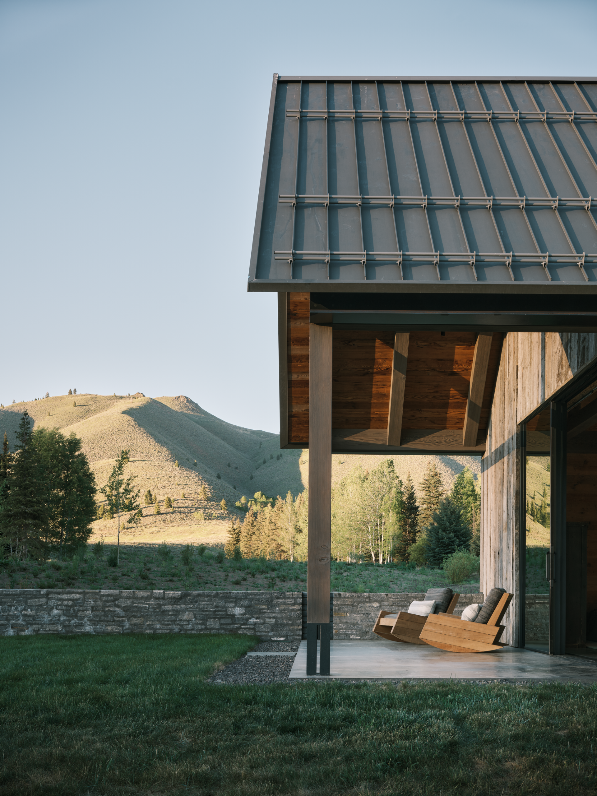 Three Barns by Field Architecture, a rural american home designed to look like a collection of old wooden barns
