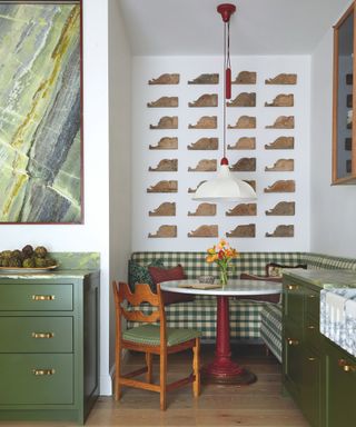 dining nook with chequered corned dining bench and green cabinetry