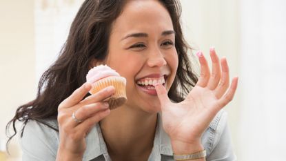 Woman eating a cupcake, which is sure to increase blood sugar