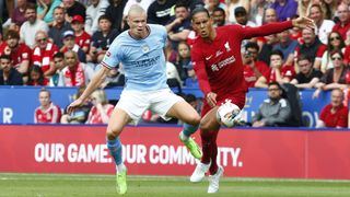 Virgil van Dijk and Erling Haaland fight for the ball