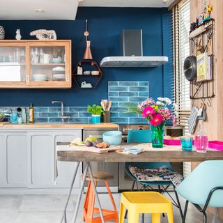 kitchen room with wooden shelves on blue wall