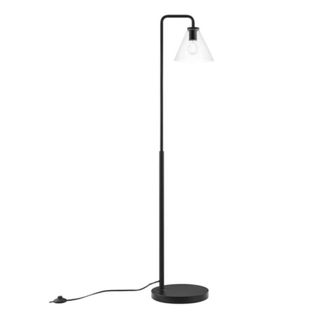 A black floor lamp with a glass lampshade and cord