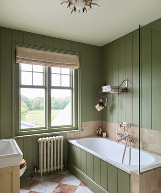 green bathroom with paneling and a red and white marble checkerboard floor