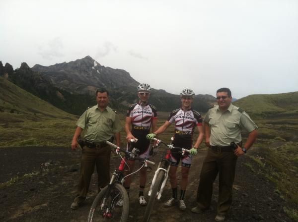 Jason Sager and Blake Harlan pose with two locals