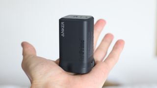 Anker Prime 100W charger held in a hand