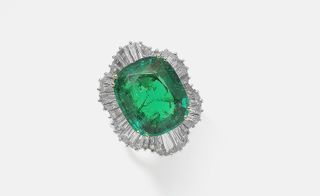 Emerald and diamond cluster ring, with undulating border of tapered baguette-cut diamonds