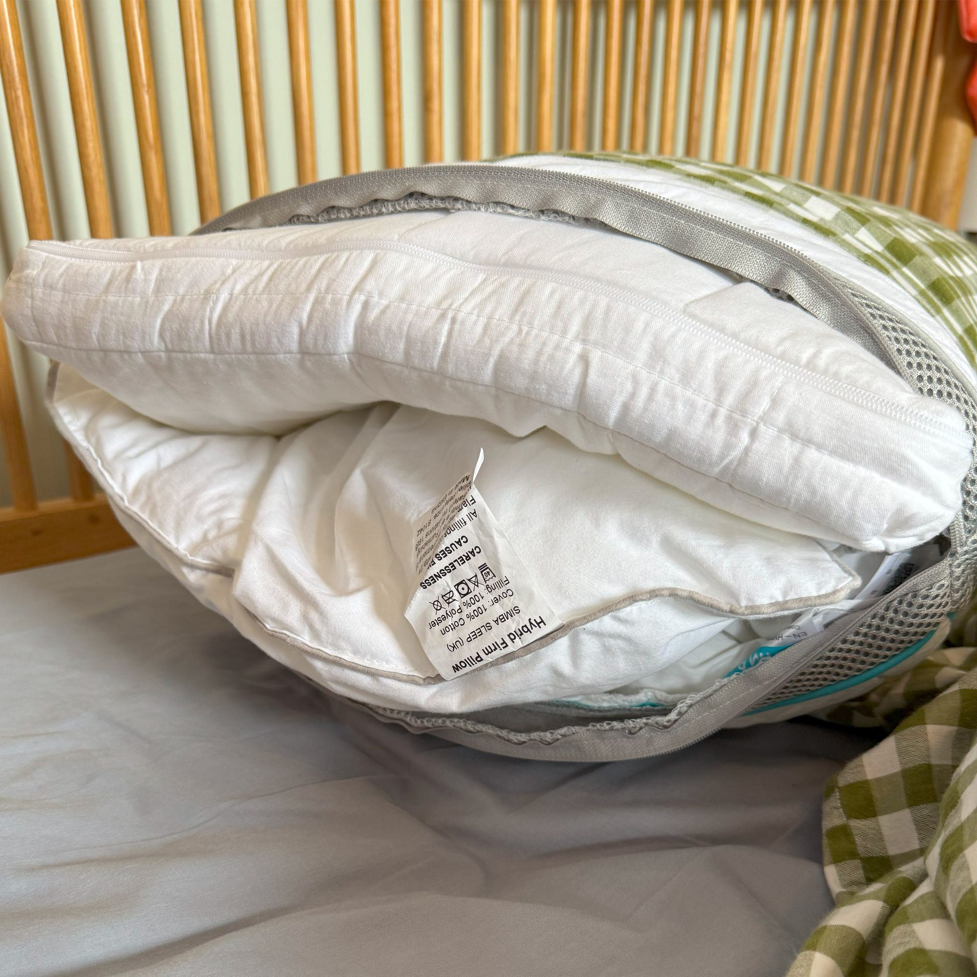 The Simba Hybrid Firm pillow in a green gingham pillowcase