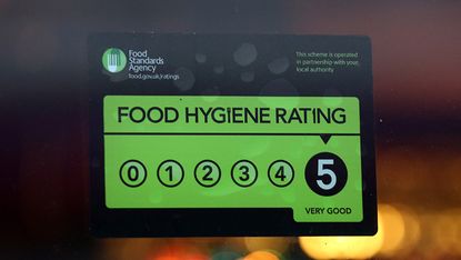 LONDON, ENGLAND - FEBRUARY 09: A Food Standards Agency rating certificate is pictured in the window of a restaurant on February 9, 2015 in London, England. Claims have been made that some res