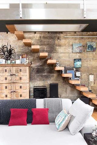 19th century country house feature wall with exposed brickwork and wood statement staircase