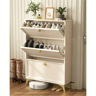 A cream shoe cabinet with flip-up bins to hide shoes in an entryway