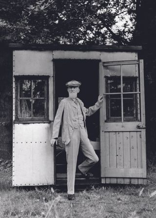 George Bernard Shaw stands outside 'London', the writing shed at the bottom of his garden. Picture: Alamy