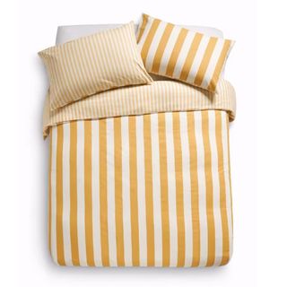 A yellow and white striped bedding set