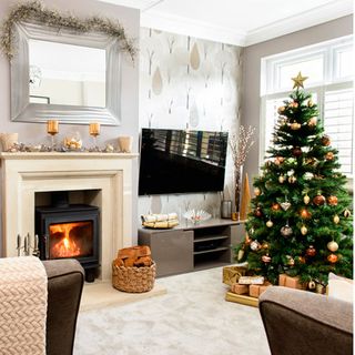 living room with christmas tree and tv on wall