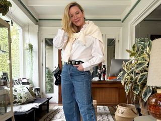 Erin Walsh wears a white shirt and jeans