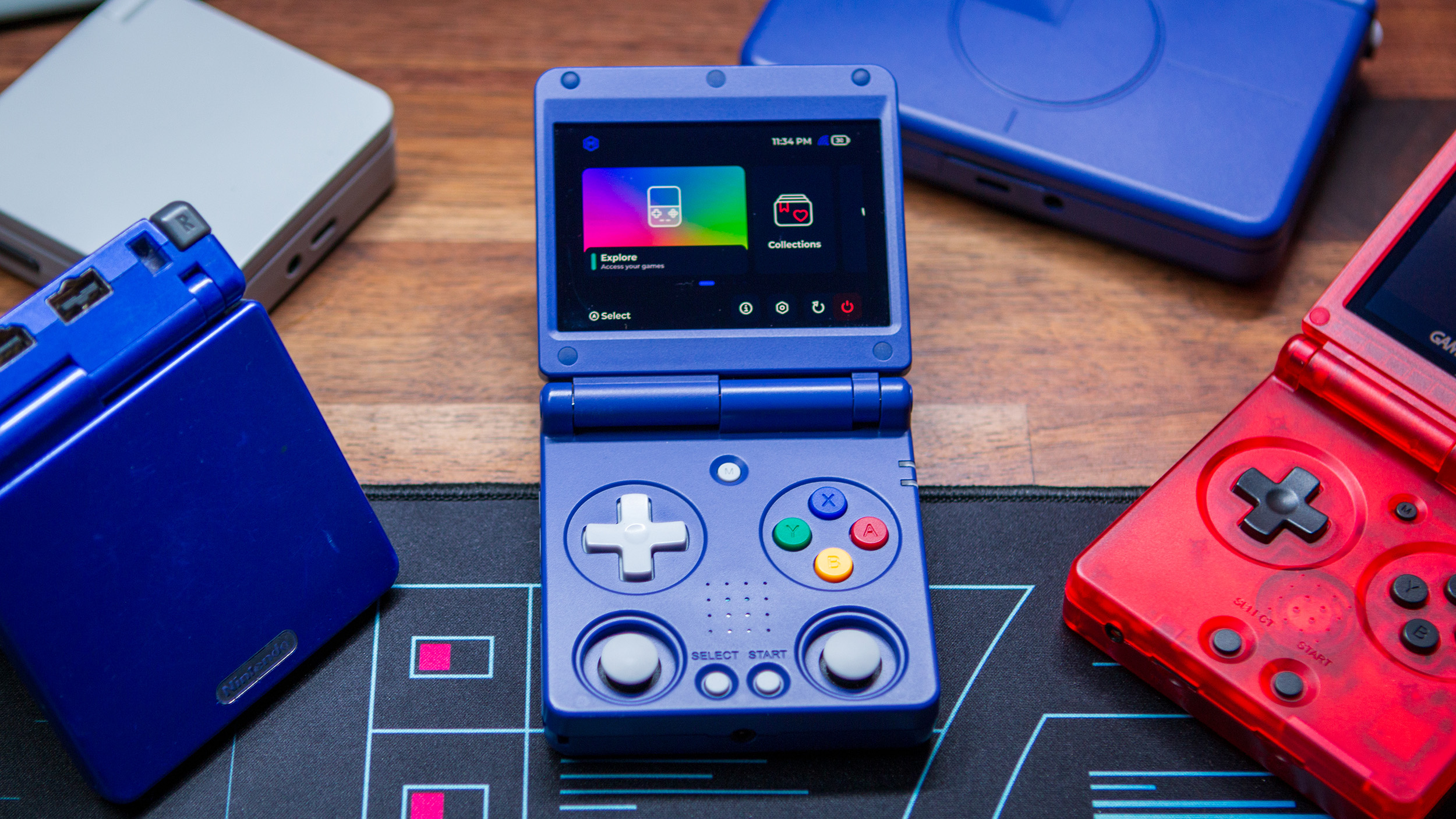 Anbernic RG34XXSP surrounded by other clamshell handhelds