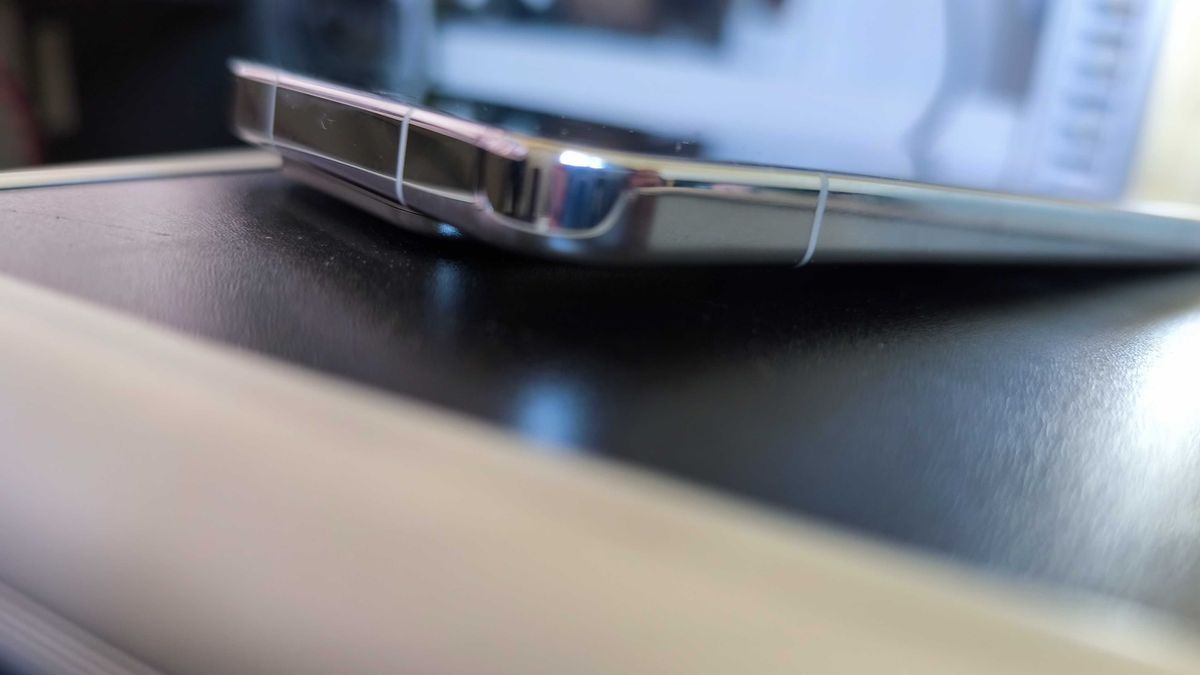 A liquid silver Xiaomi 15 on a detailed blue background