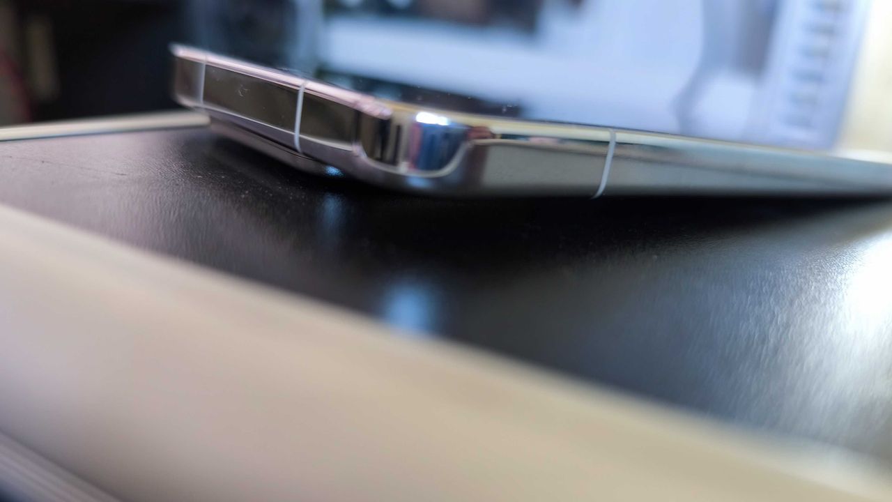 A liquid silver Xiaomi 15 on a detailed blue background